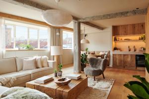 a living room with a couch and a table at 1 Hotel Copenhagen in Copenhagen