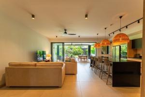 a living room with a couch and a kitchen and a table at Modern and comfortable apartment in Pointe aux Cannoniers