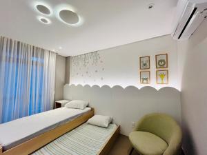 En eller flere senge i et værelse på Galapagos1402 - Cobertura com Hidro e Jacuzzi Privativas