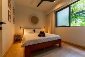 a bedroom with a bed with a teddy bear on it at Modern and comfortable apartment in Pointe aux Cannoniers +28 photos