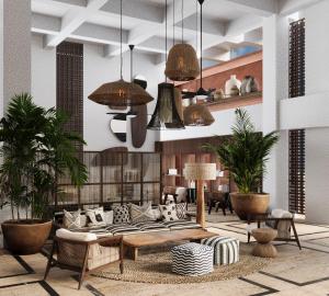 Corendon Hydros Club Kemer في كيمير: غرفة معيشة مع أريكة والنباتات الفخارية +40 صورة