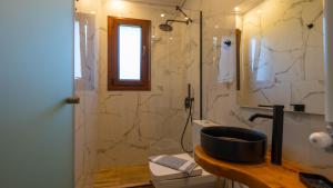 a bathroom with a sink and a shower with a toilet at Stilvi in Tsagarada +58 photos