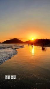 persone che camminano sulla spiaggia al tramonto di Suíte Capiá a Ubatuba Altre 2 foto