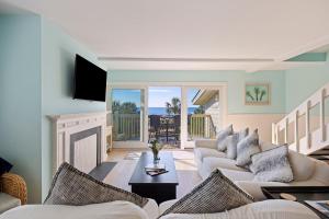 a living room with a couch and a fireplace at SG3C: 3C Seagrove Villa in Isle of Palms