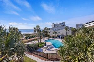 an aerial view of a house with a swimming pool and the ocean at SG3C: 3C Seagrove Villa in Isle of Palms