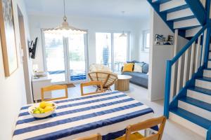 a blue and white living room with a blue staircase at La Jura in Podlesice