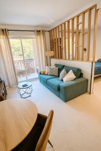 a living room with a couch and a table at T1 bis rénové, clim et confort - Saint Raphaël in Saint-Raphaël