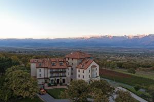 an aerial view of a mansion with mountains in the background at AGARANI Estate in Tʼelavi