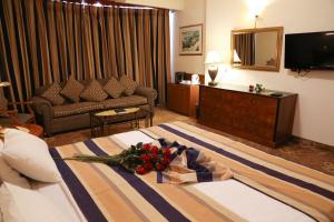 a hotel room with a bed with flowers on it at Shepherd Hotel in Bethlehem