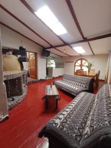 a living room with two couches and a fireplace at Huilka Mayu in Urubamba