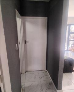 a hallway with a white door in a room at Beach Vibes Villa in Cape Town