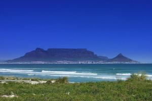 a view of the ocean with a mountain in the background at Beach Vibes Villa in Cape Town +6 photos