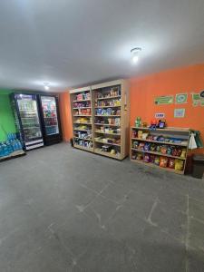 a store room with two refrigerators and shelves of goods at Eco Paradise 129 in Caucaia