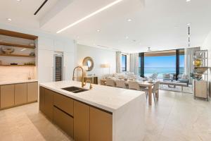 a kitchen and living room with a dining room and a table at Beachfront 3 bedroom Luxury Residence in Nassau