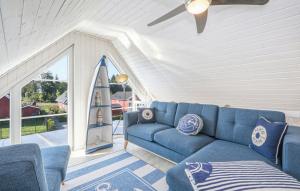 a living room with a blue couch and a surfboard at Haus Ankerplatz in Wandlitz