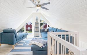 a living room with blue chairs and a ceiling fan at Haus Ankerplatz in Wandlitz +16 photos
