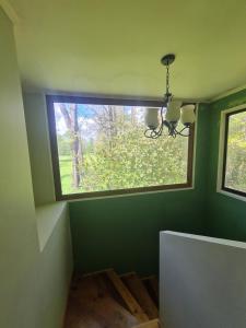 a small window in a room with a wooden floor at Nido Del Bosque in Pucón