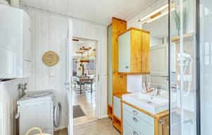 a kitchen with a sink and a washer and dryer at Haus Feldblick in Wandlitz