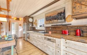 a kitchen with wooden cabinets and a table and a counter at Haus Feldblick in Wandlitz