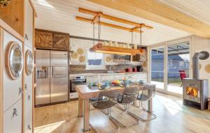 a kitchen with a table with chairs and a refrigerator at Haus Feldblick in Wandlitz +11 photos