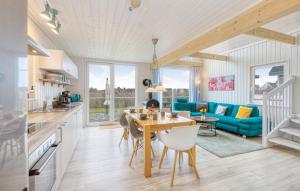 una cucina e un soggiorno con un tavolo e un divano blu di Villa Kunterbunt a Wandlitz