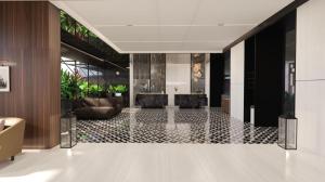 a lobby with a tile floor in a building at Intercity Hotel & Serviced Apartment Phnom Penh Downtown in Phumĭ Prêk Chrey