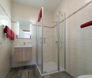 a bathroom with a shower and a toilet and a sink at Anitas Altstadtpension in Kelheim +9 photos