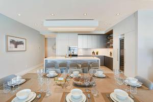 a dining room with a table and chairs and a kitchen at Beachfront 3 bedroom Luxury Residence in Nassau +39 photos