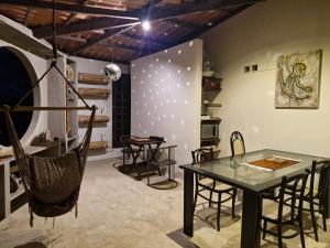 a room with a table and chairs and a hammock at Solar de Bonito in Bonito