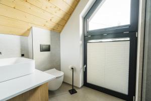 a bathroom with a toilet and a window at Tatres Bachledówka in Czerwienne +32 photos