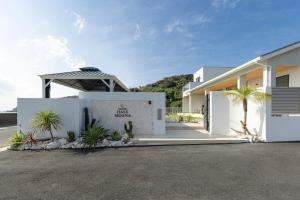 una casa bianca con palme nel vialetto di Hale Moana a Itoshima