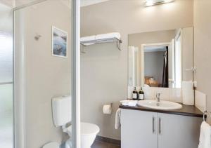 a white bathroom with a toilet and a sink at LUXURY 3-Bed Home Perfect for Families & Groups in Sebastopol +28 photos