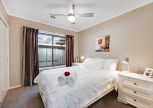 a bedroom with a large white bed with two towels at LUXURY 3-Bed Home Perfect for Families & Groups in Sebastopol