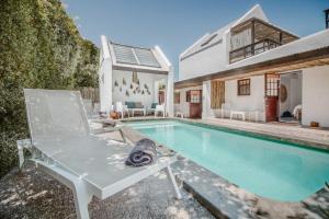 a villa with a swimming pool and a house at Gonana Guesthouse in Paternoster