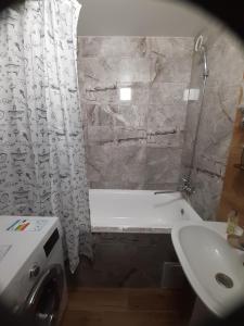 a bathroom with a tub and a sink and a shower at Квартира в Коломиї in Kolomyya +9 photos