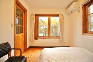 a bedroom with a bed and a window at THE KOYA Nagano in Nagano