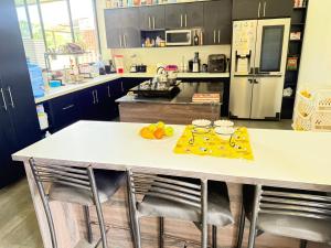 a kitchen with a counter with a table with fruit on it at Villa Mariaclaudia in Macas