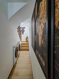 a hallway with a stairwell with a painting on the wall at Pettit Lion in Villena +3 photos