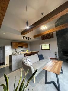 a living room with a couch and a table at The Provence Village in Bukovinka