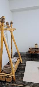 a wooden stand with towels on a wooden floor at Apartman Maximus in Kupres