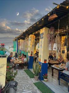 a group of people sitting at tables on a patio at Hotel Poonam Pushkar in Pushkar +104 photos