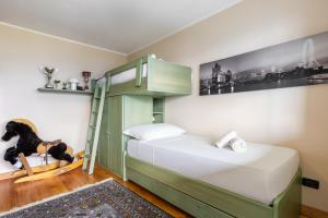 a bedroom with a bunk bed with a ladder at Hostdomus - Rooftop Deluxe Suite in Sestriere