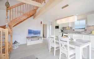 a kitchen and dining room with a table and chairs at Haus zum maritimen Blick in Wandlitz