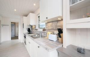 a kitchen with white cabinets and a counter top at Haus zum maritimen Blick in Wandlitz