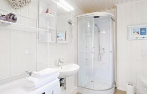 a white bathroom with a shower and a sink at Haus zum maritimen Blick in Wandlitz