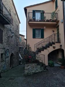 an alley in an old building with a balcony and stairs at Casa alta in Allerona