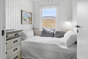a white bedroom with a bed and a window at 1014-Thisted-Sletningen-7 in Torsted