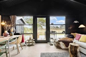 a living room with a couch and a table at 1014-Thisted-Sletningen-7 in Torsted +14 photos