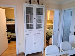 a white cabinet in a room with a bedroom at Jonckershof Middelkerke bungalow 26 in Middelkerke