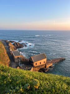 a group of buildings on the edge of the ocean at Housel Bay Hotel in Lizard